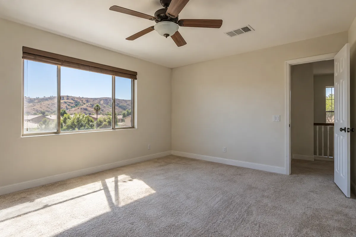 Empty upstairs room with a ceiling fan and a window with hill views, post-remediation verification in Denver, CO
